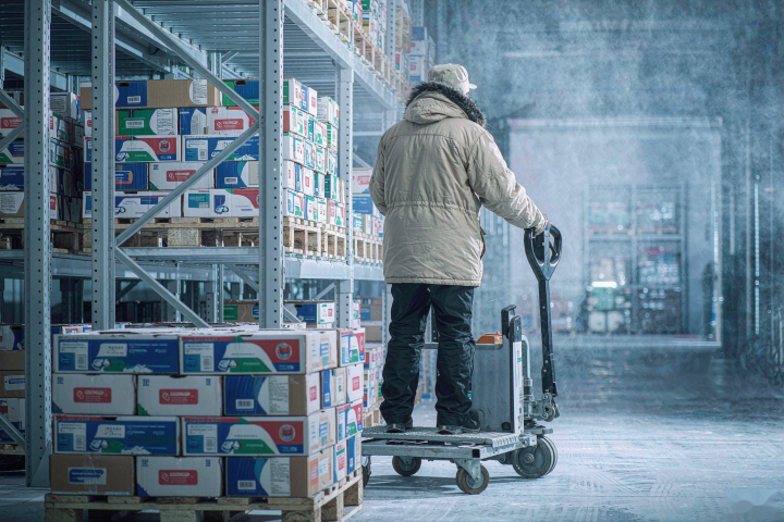 Electric pallet truck operating inside a cold storage warehouse